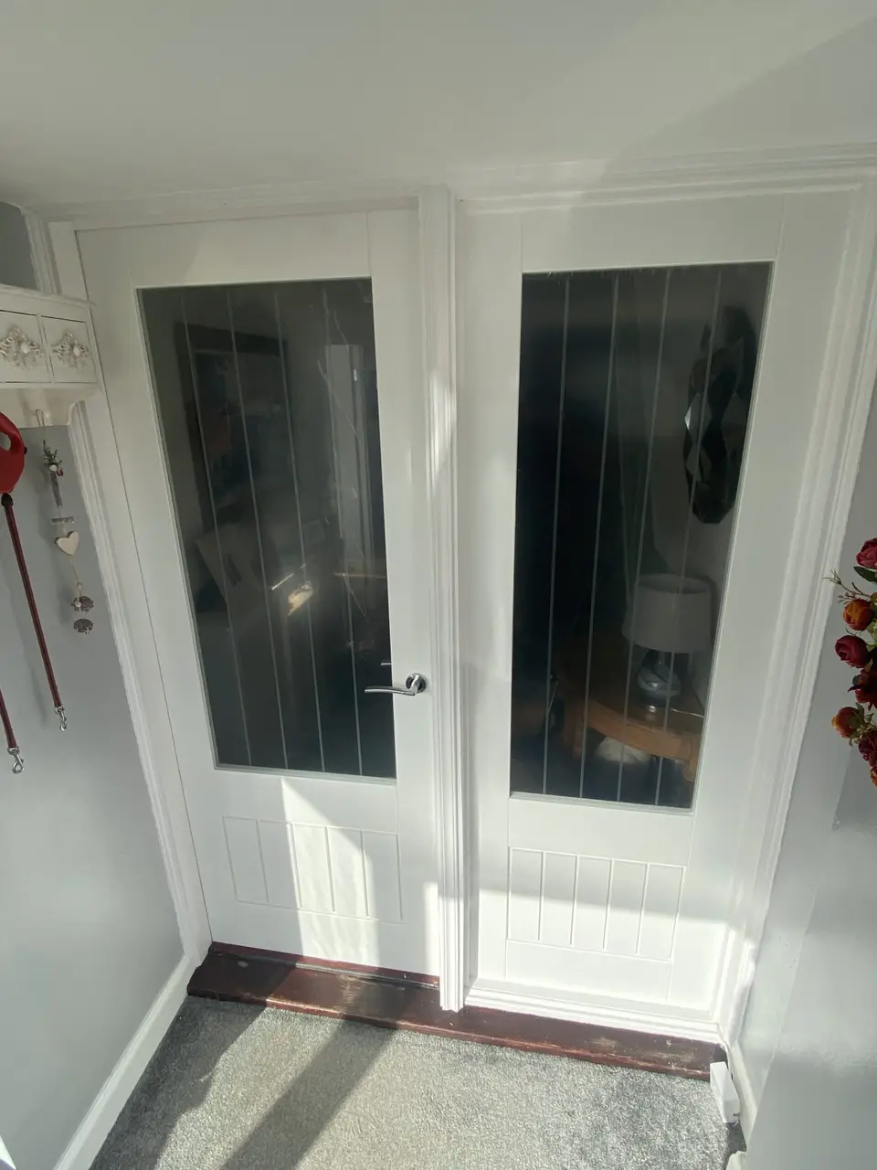 Pair of white glazed internal doors in a porch, one of the glazed door styles we supply and fit in County Durham