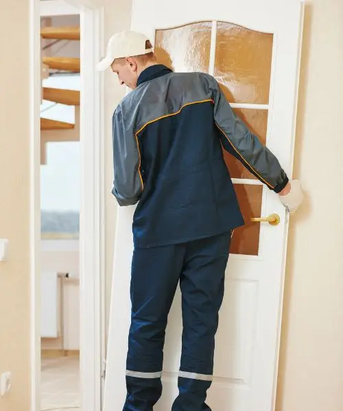 Internal door fitting in Newcastle Door fitter hanging a white glazed internal door, the door fitting work we carry out in Newcastle