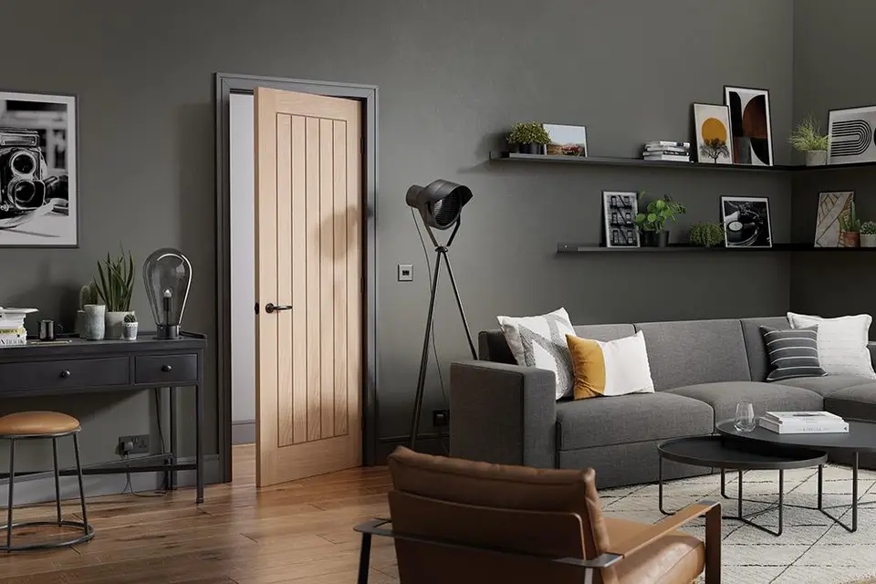 Oak cottage-style internal door in a grey living room, a style of oak door we supply and fit in Northumberland