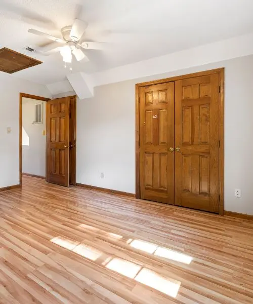 Pair of oak panel doors in a bright bedroom, a door pair of the kind we fit for wide openings in County Durham
